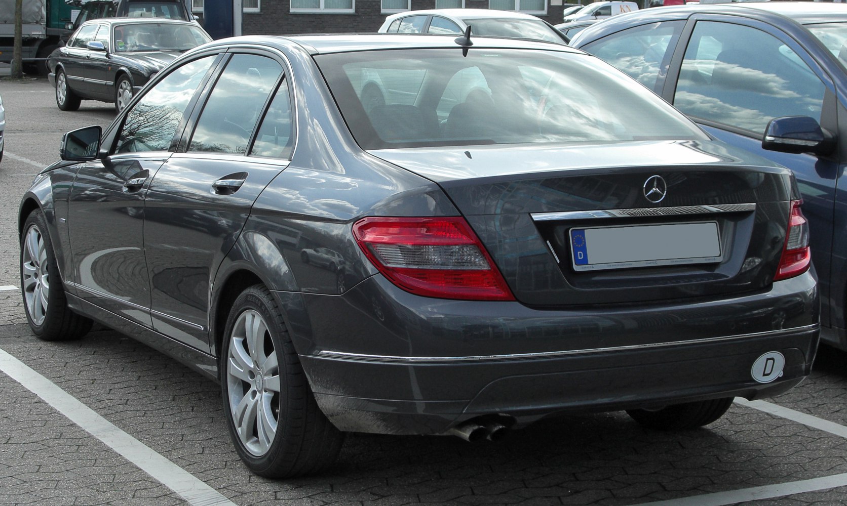Rear and side view of sedan with distinctive tail lights and chrome trim