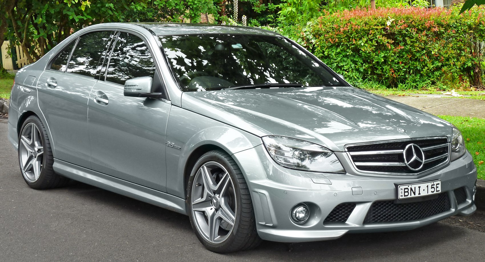 Silver sedan with AMG front styling and alloy wheels parked outdoors