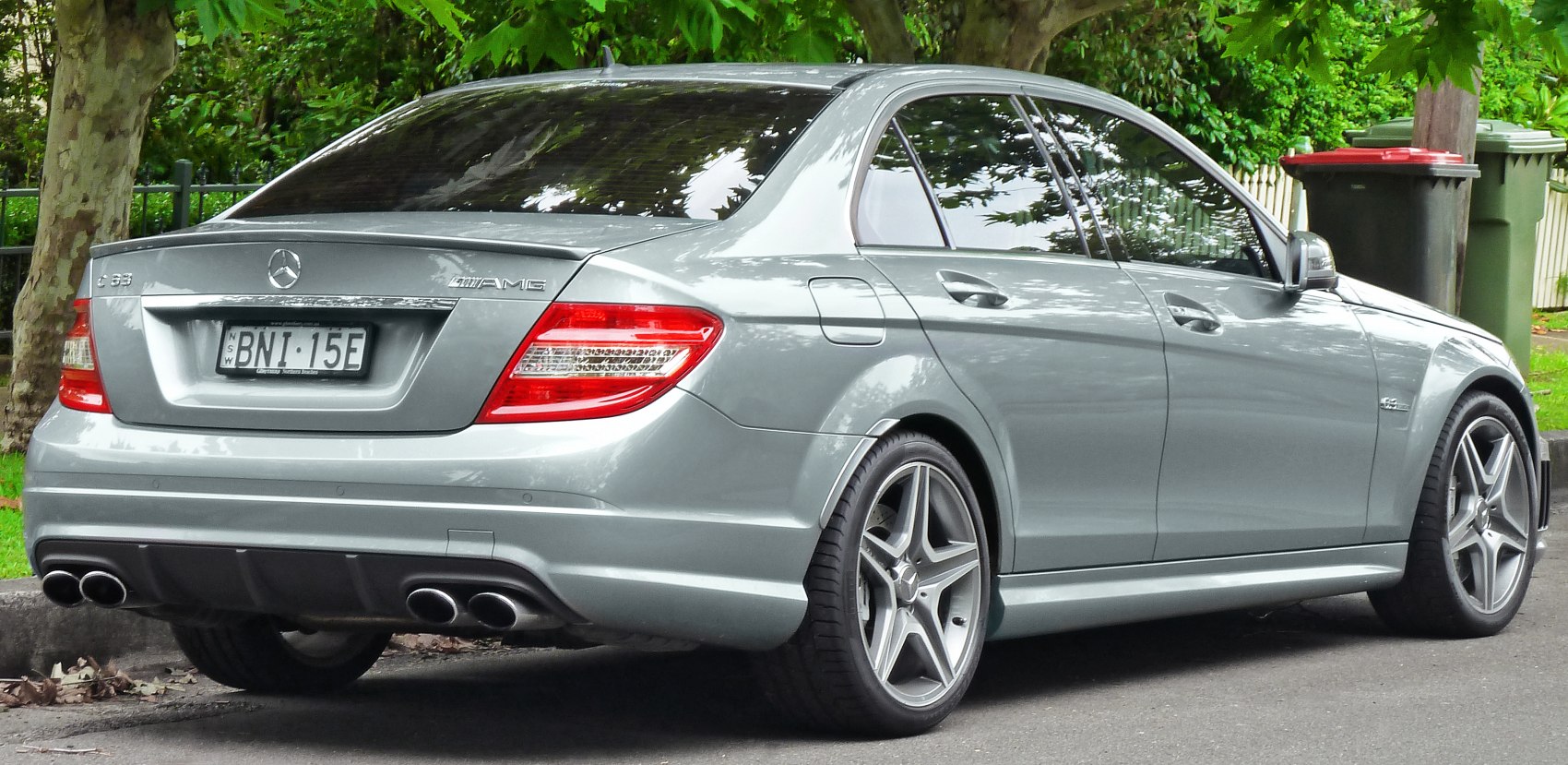Rear view with quad exhaust and AMG badge on an alloy wheel sedan