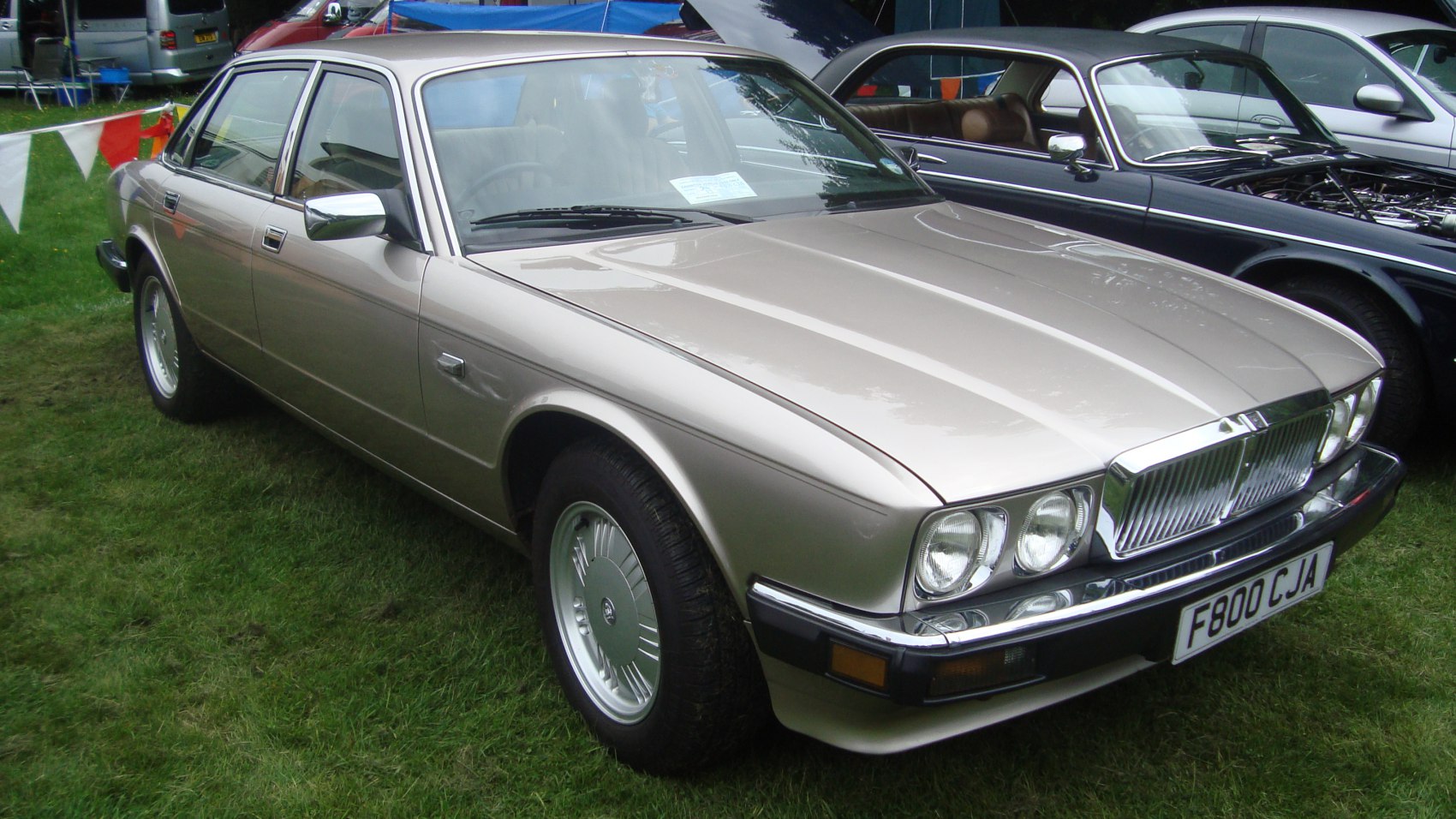 Rectangular quad headlights and chrome grille on classic luxury sedan