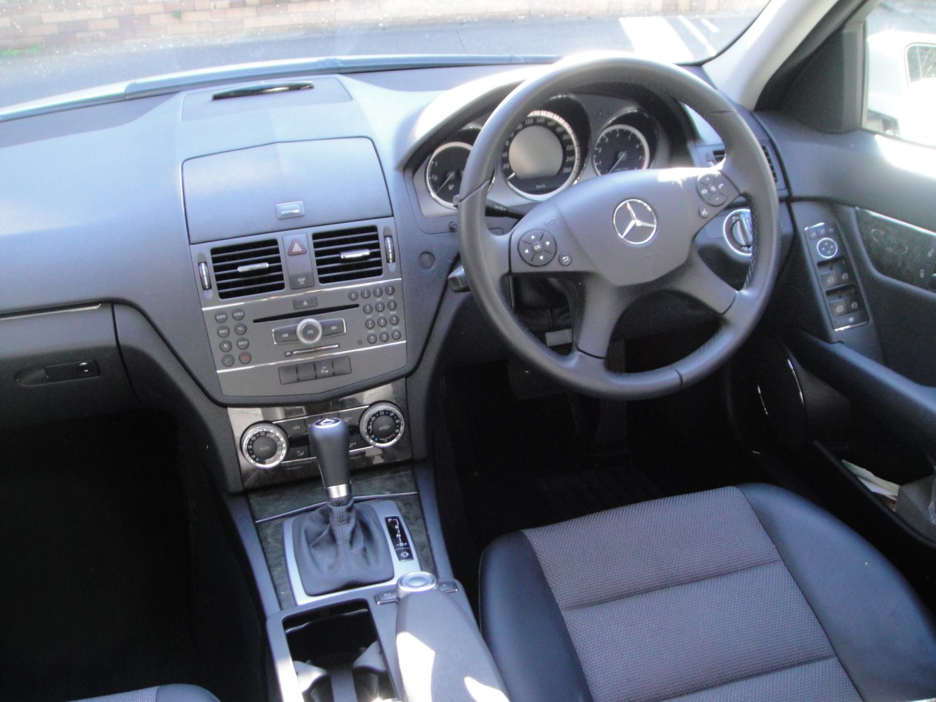 Steering wheel and dashboard with center console and gear shift