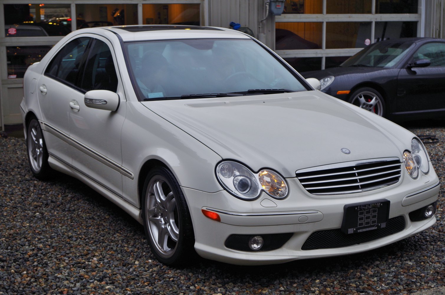 White sedan with distinct dual round headlights and alloy wheels