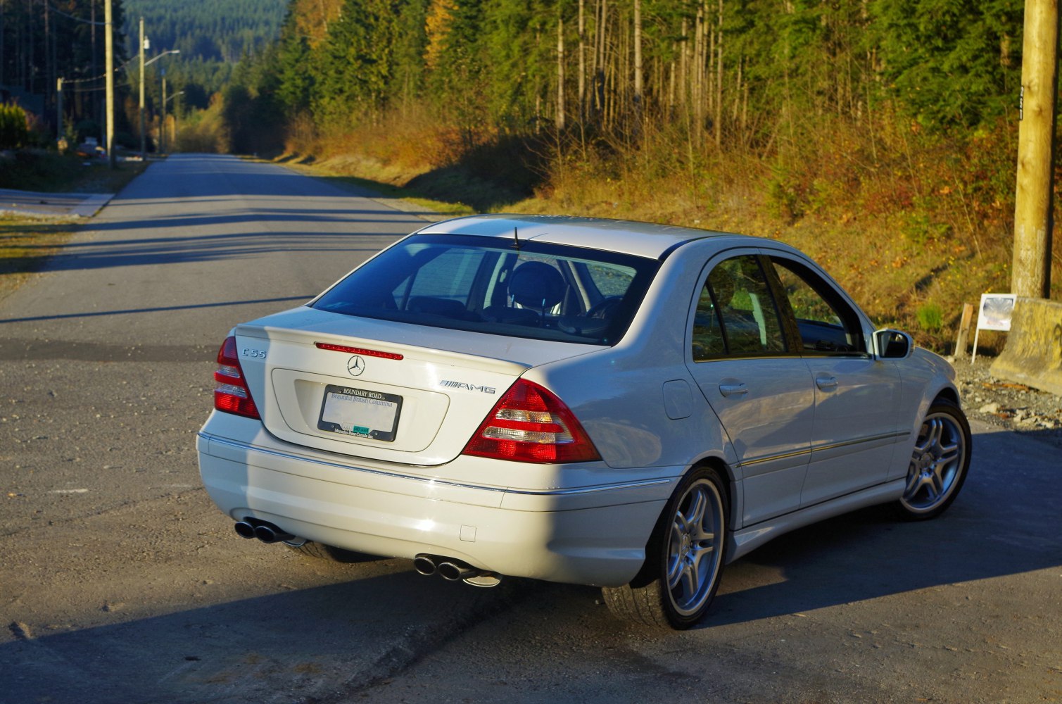 Rear view with AMG badge and quad exhaust pipes on a sedan.