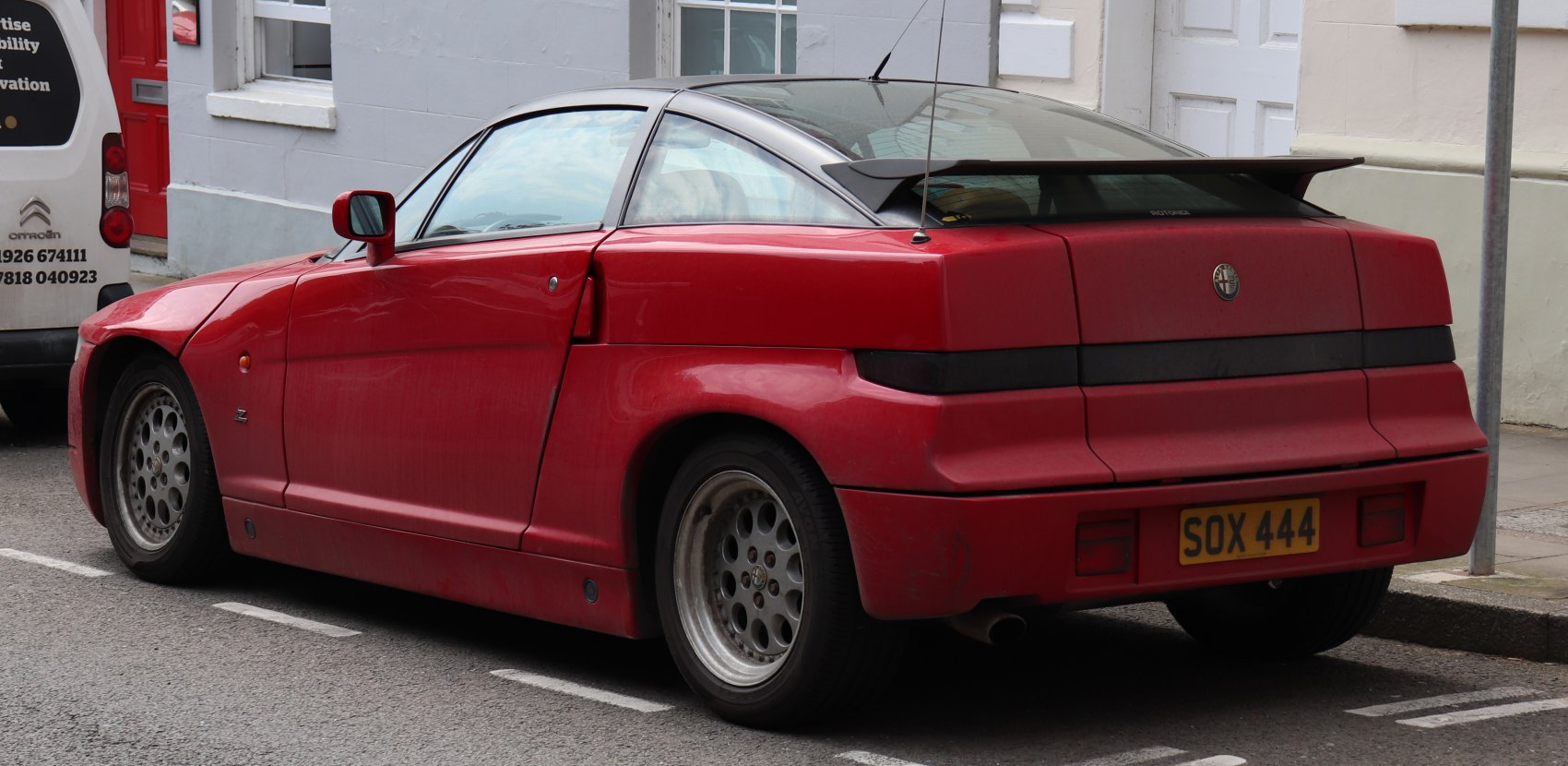 Angular rear design with rear spoiler and multi-hole alloy wheels