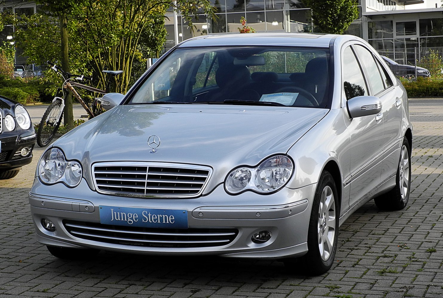 Silver sedan front with dual round headlights and distinctive grille