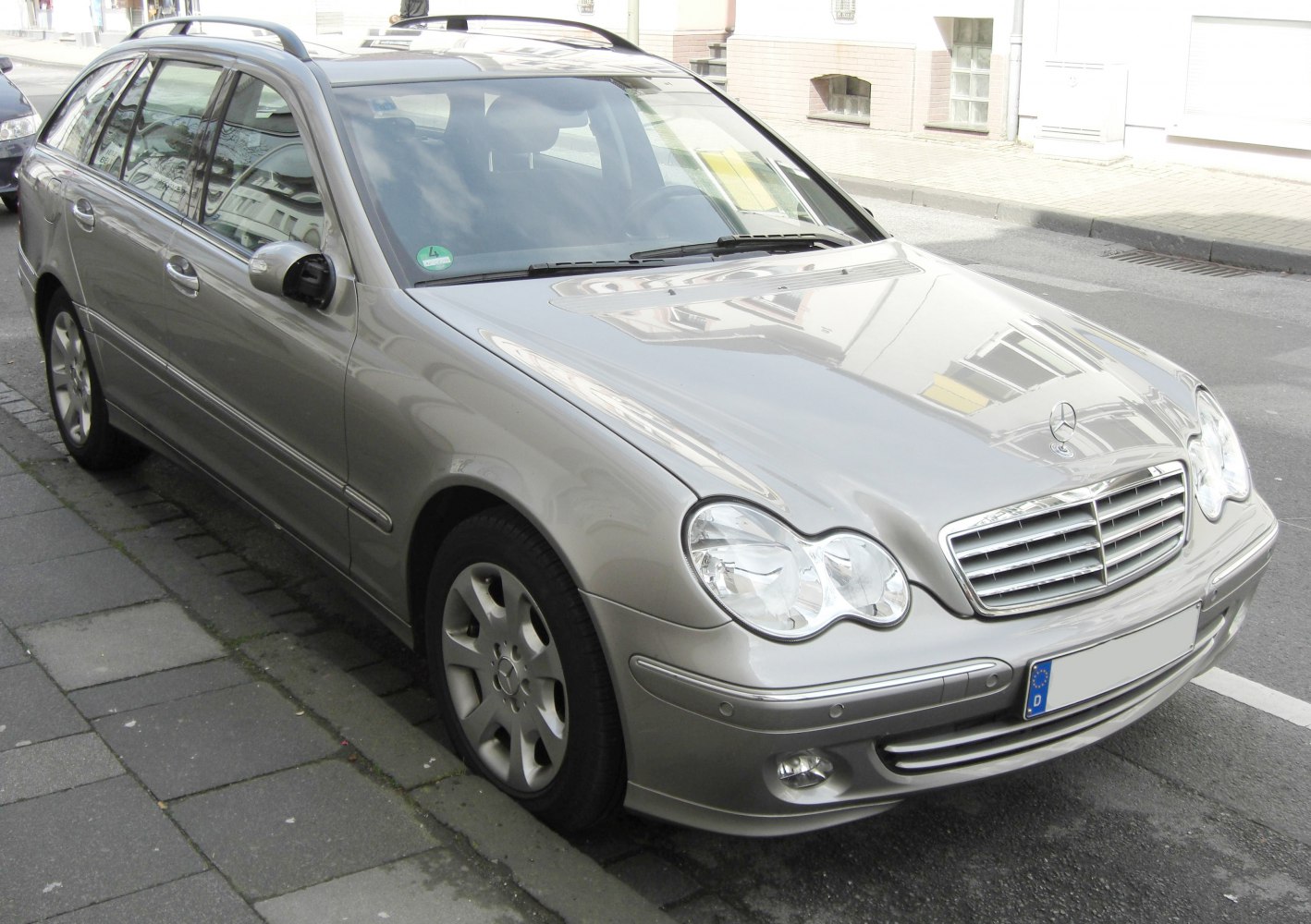 Silver estate car with twin circular headlights and chrome grille