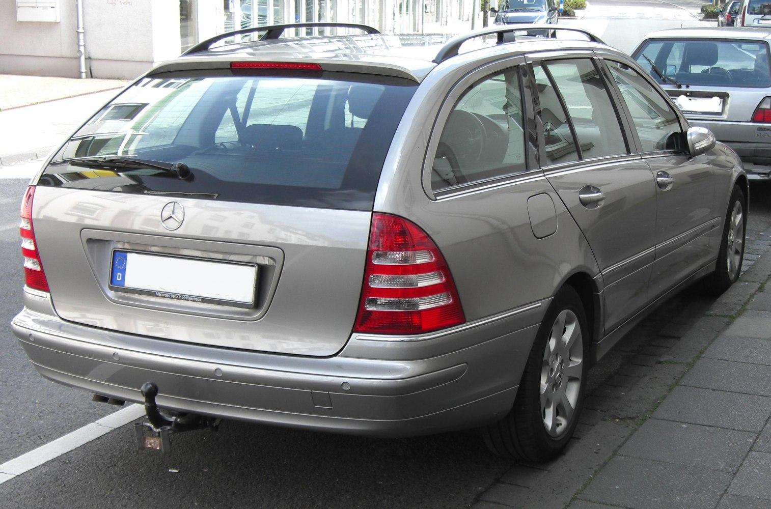 Silver station wagon rear with roof rails and tow hitch