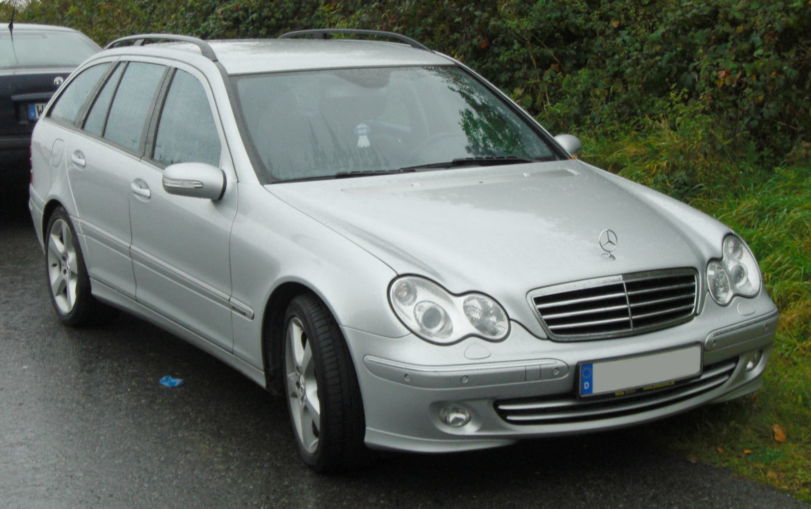 Silver station wagon with roof rails and dual rounded headlights