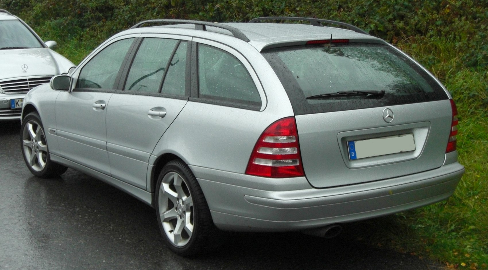Silver station wagon rear with roof rails and alloy wheels