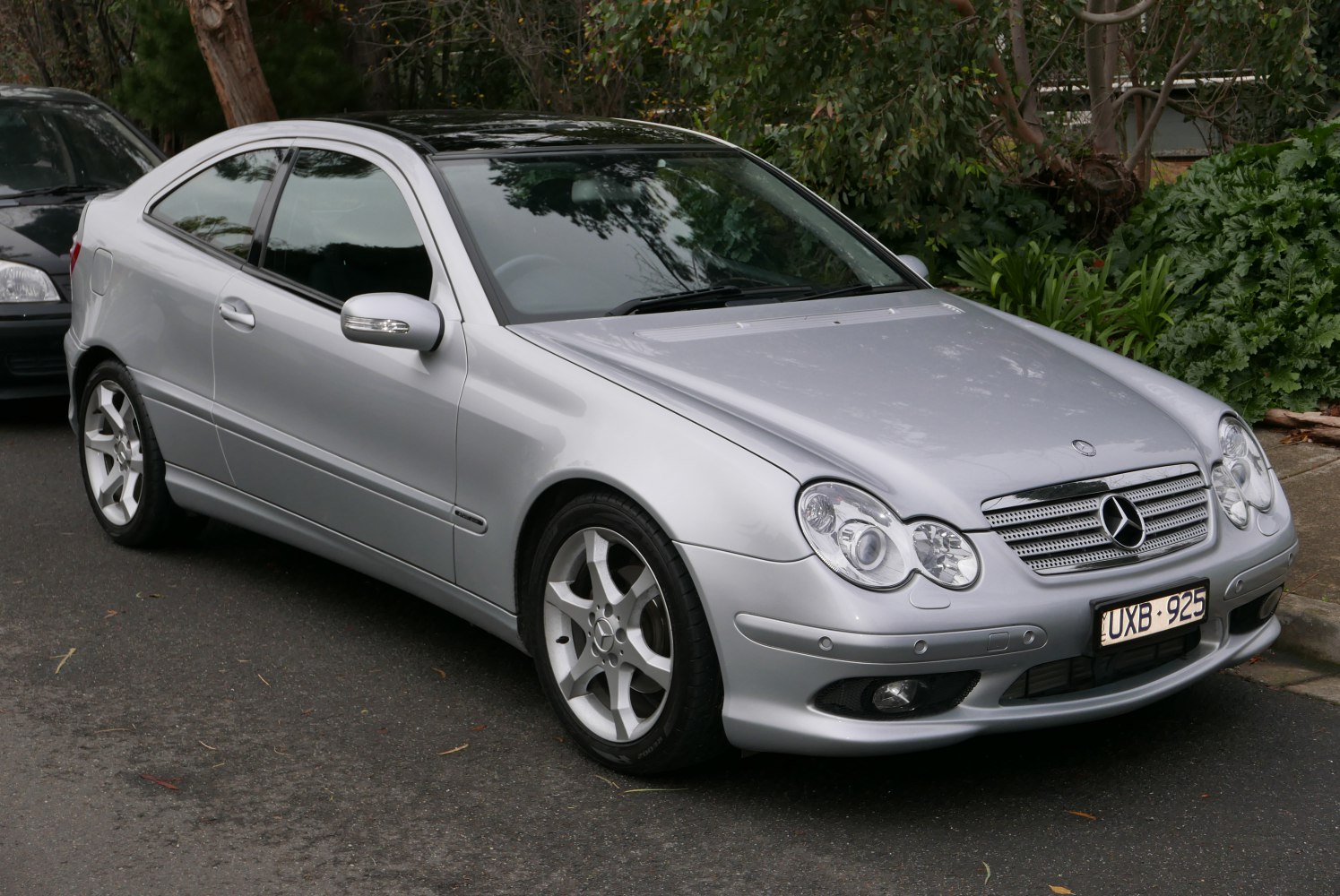 Silver coupe with dual round headlights and alloy wheels