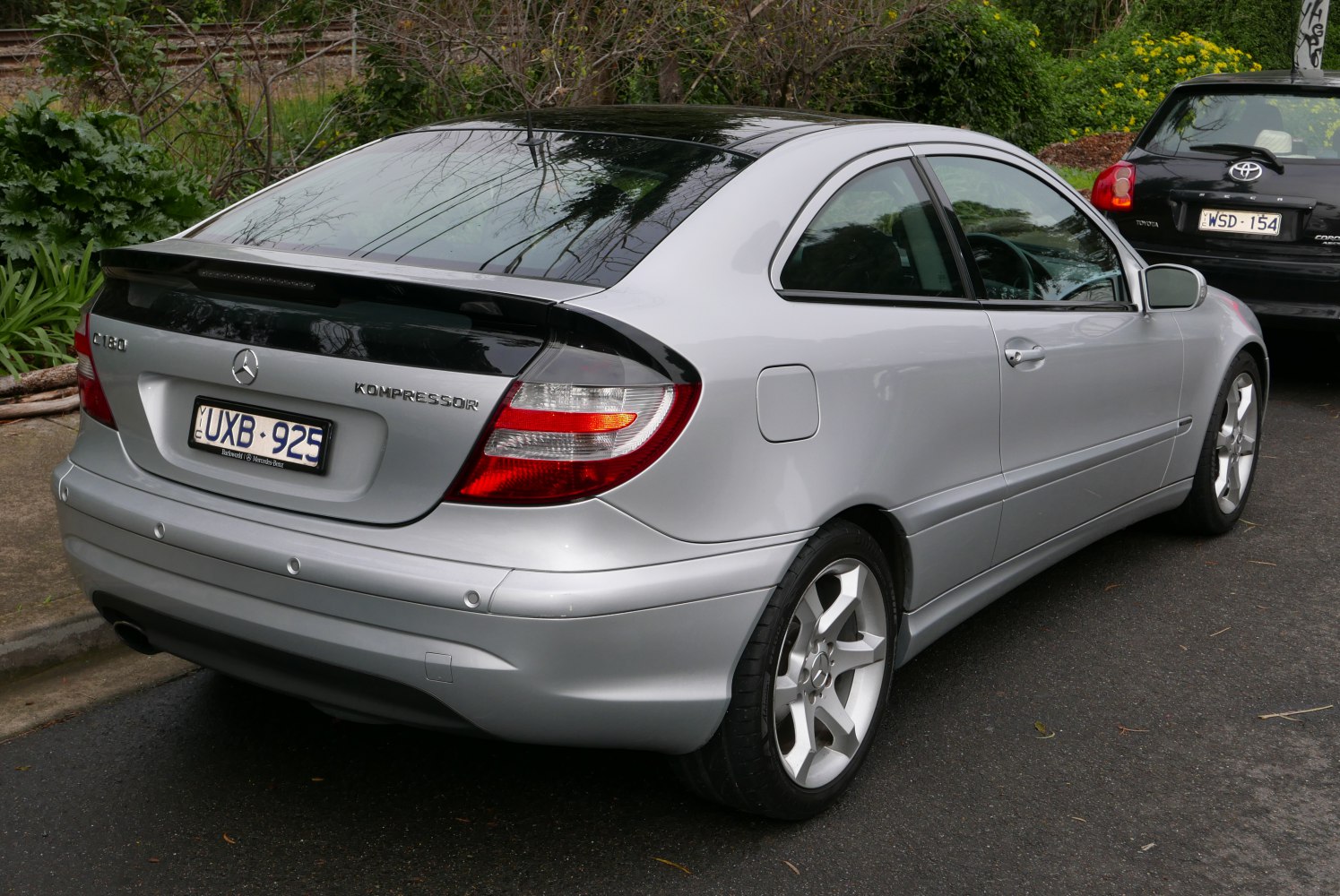 Sport coupe rear with spoiler, alloy wheels, and detailed tail lights