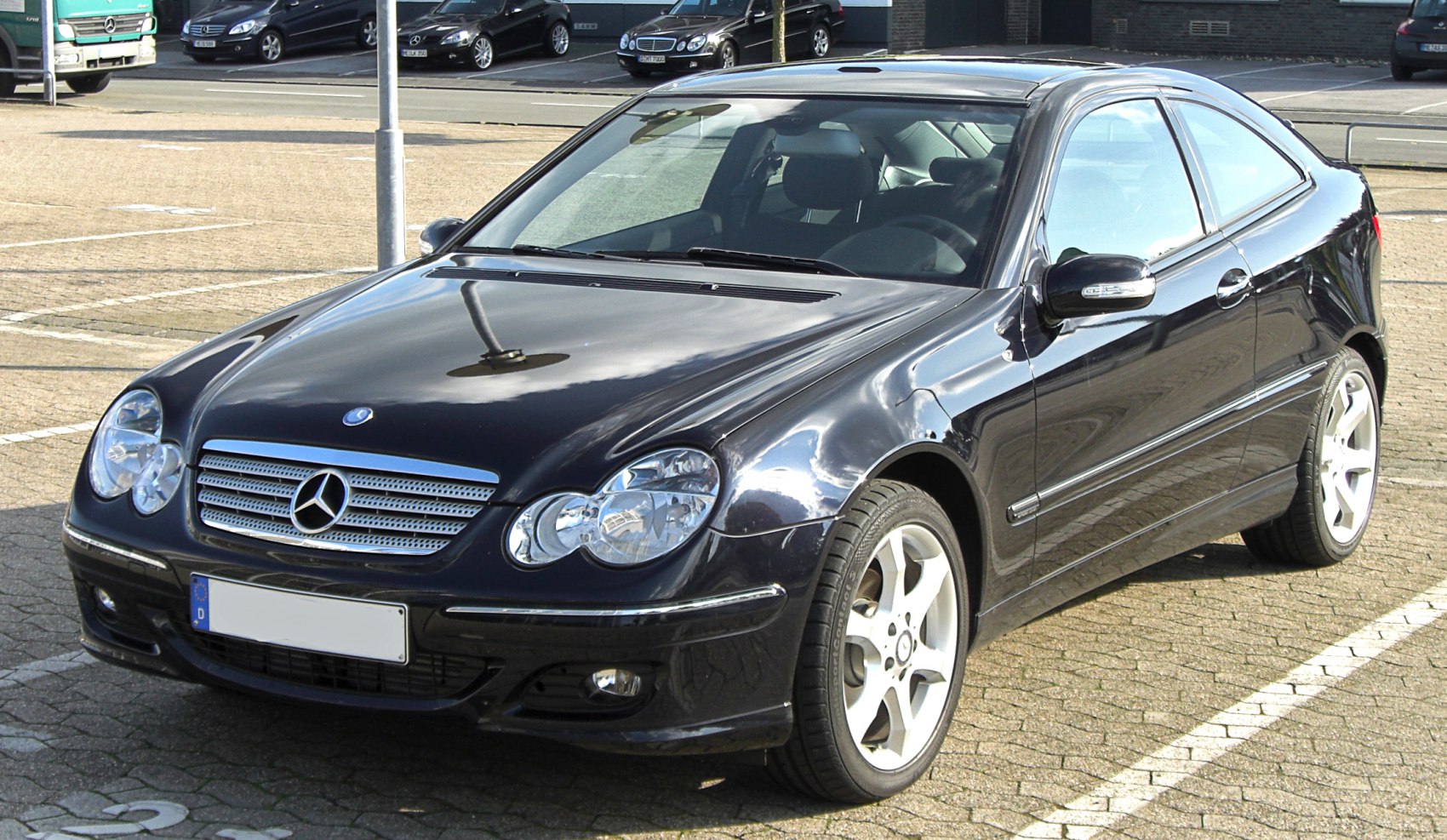 Front angled view of a coupe with distinctive headlights and grille