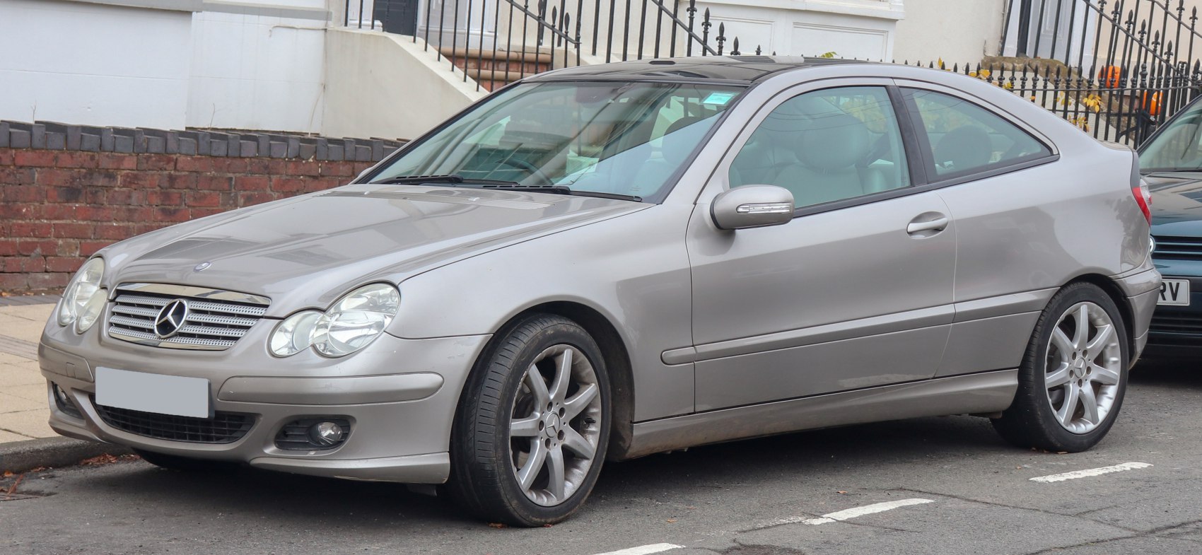 Front side view with distinctive headlights and sleek coupe design