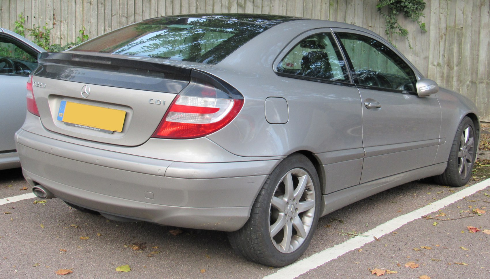 Silver compact coupe rear with spoiler and distinctive taillights