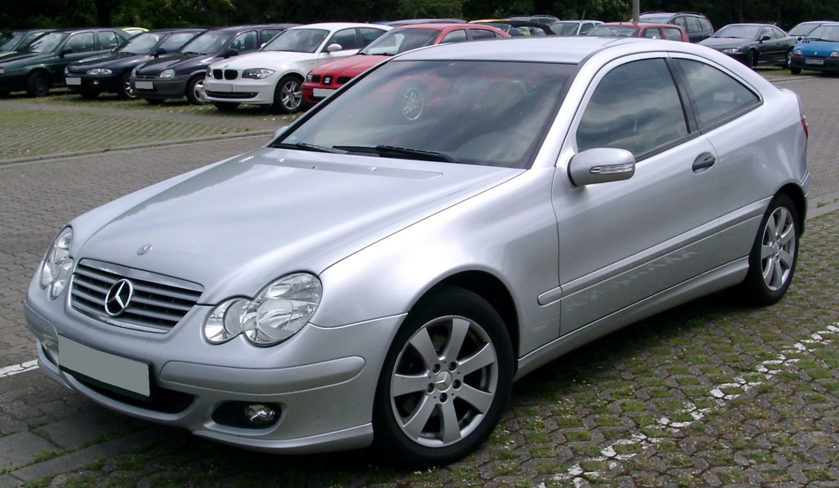 Silver coupe with sleek aerodynamic design and prominent alloy wheels