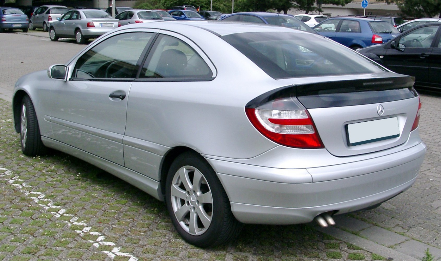 Silver sport coupe with rear spoiler and dual exhaust