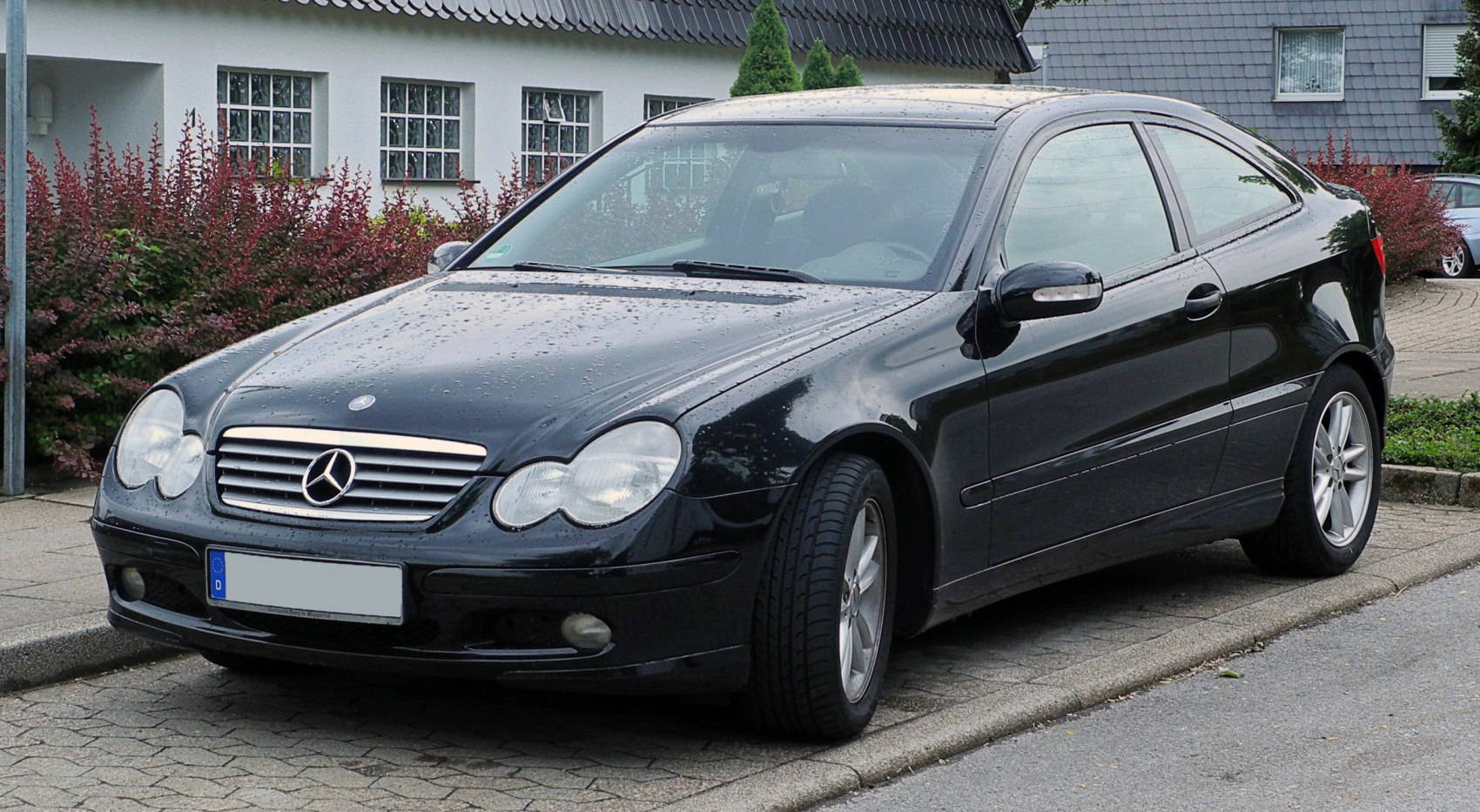 Dual rounded headlights and sleek compact coupe body design