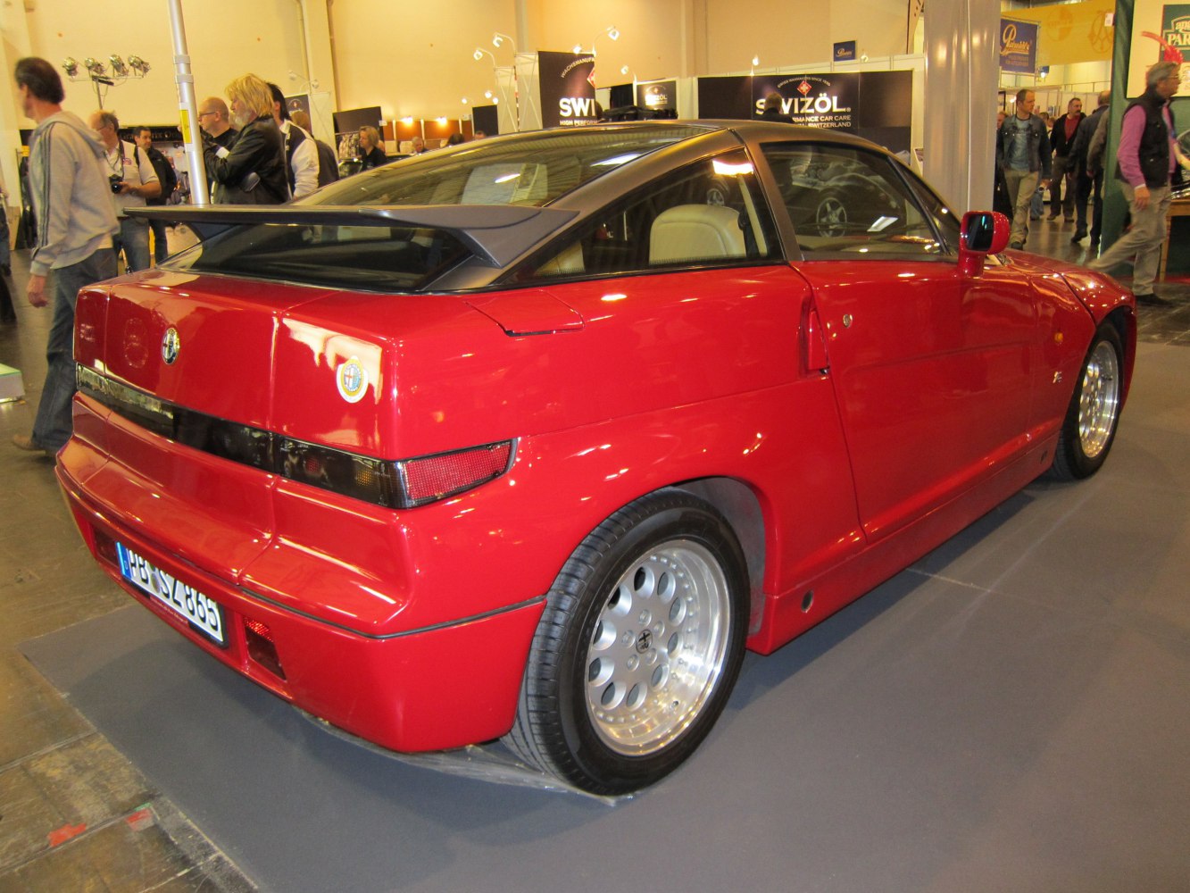 Red sports coupe rear side with aerodynamic spoiler and unique angular design