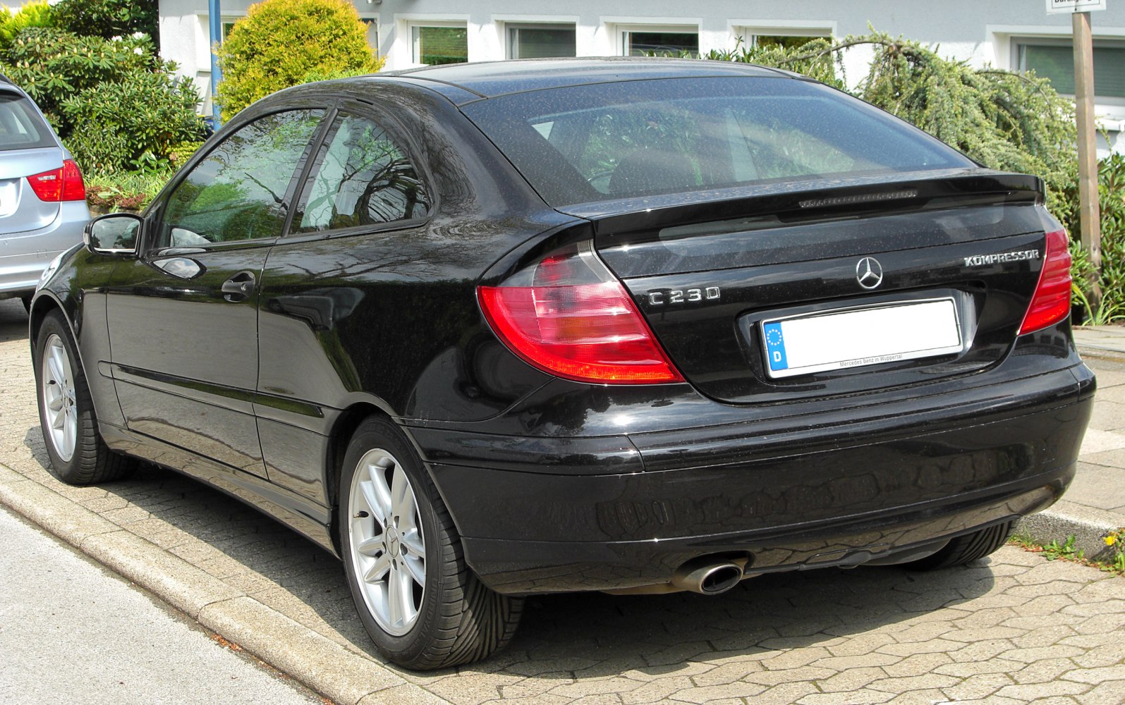 Rear view of sleek black sport coupe with distinctive tail lights