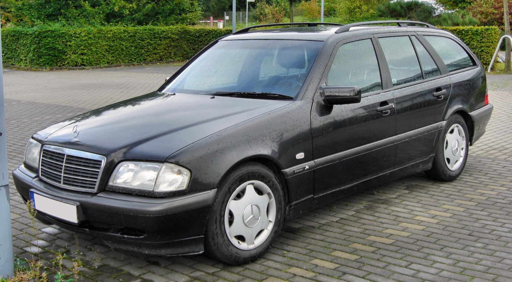 Black estate car with roof rails and classic grille