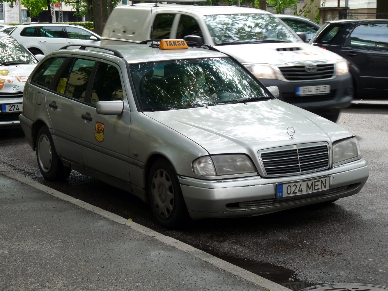 Silver station wagon with taxi roof sign and classic front grille