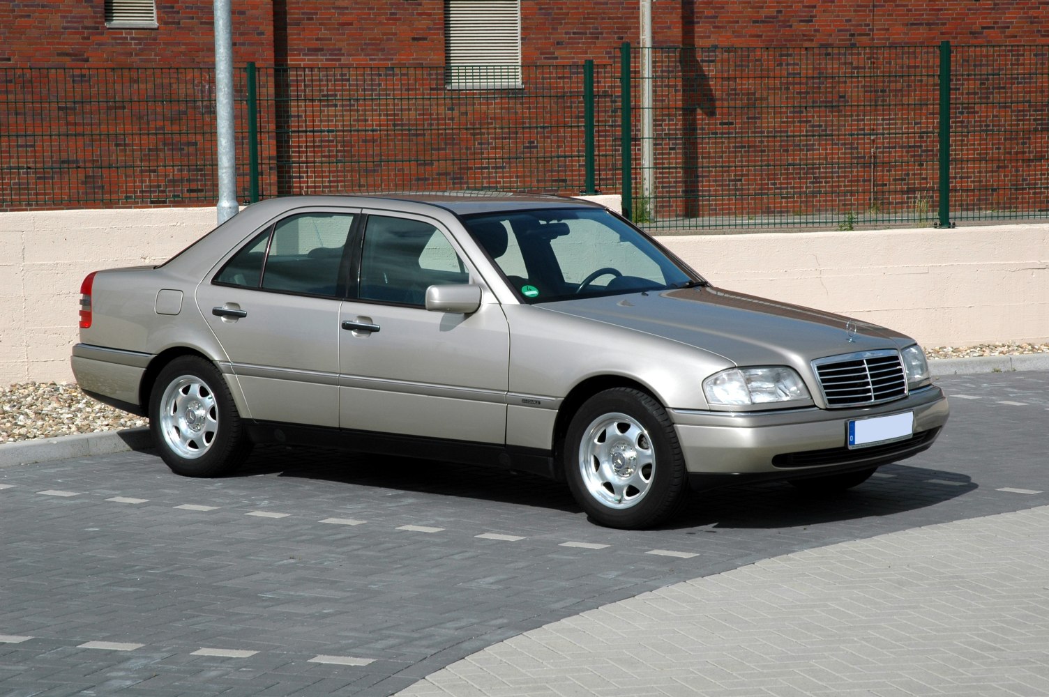 1990s sedan with alloy wheels and chrome grille