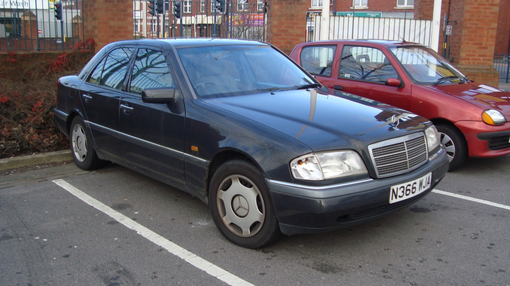Classic sedan with chrome grille and rounded headlights from early 90s