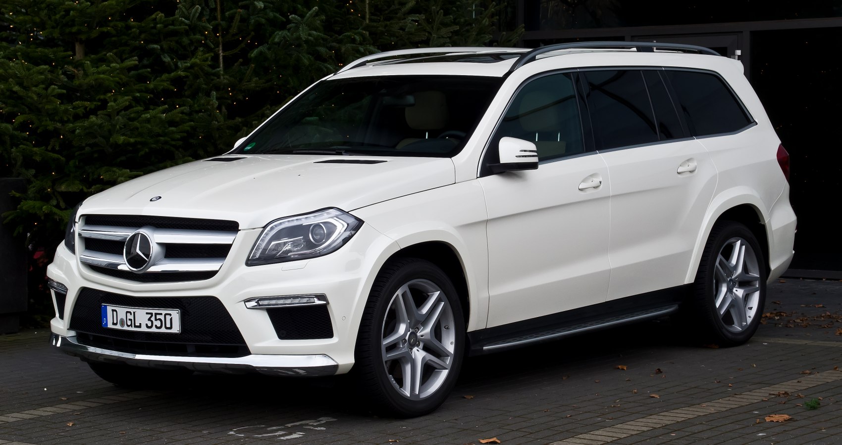 Front side view of luxury SUV with grille and alloy wheels