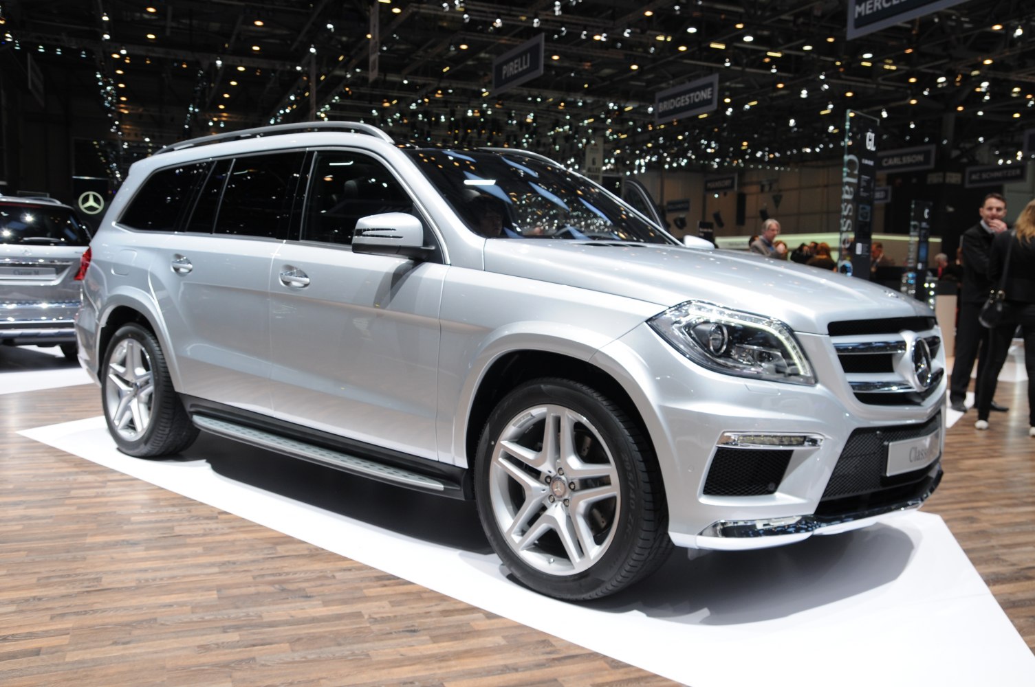 Silver luxury SUV front side view with alloy wheels