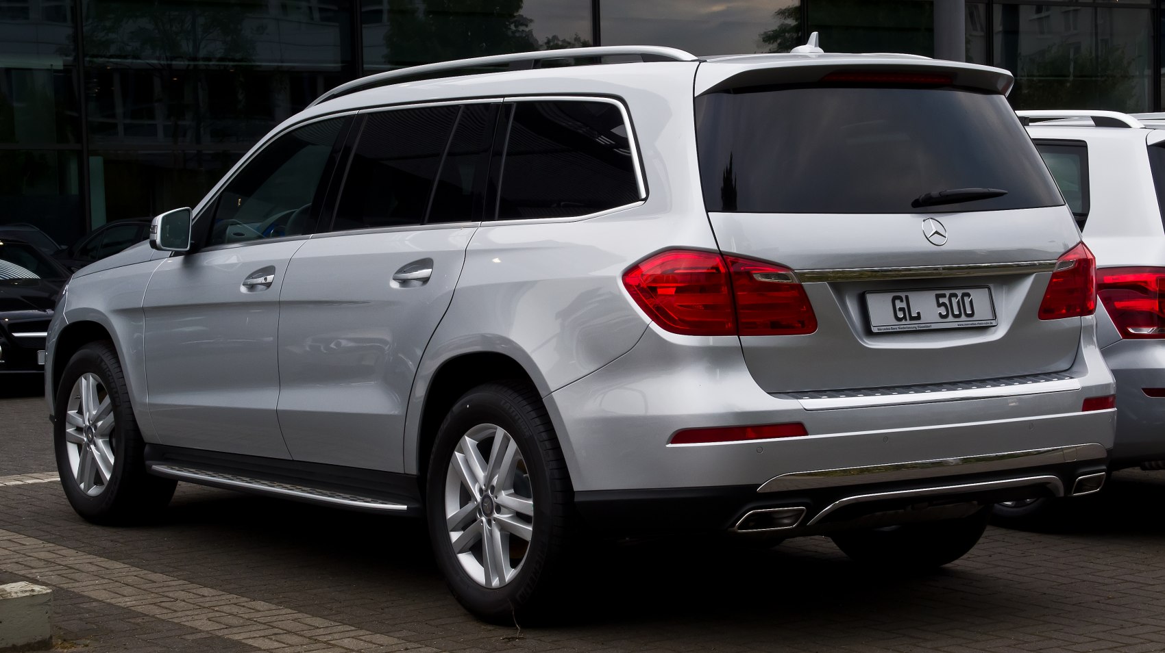 Rear side view of luxury SUV with roof rails and distinctive taillights