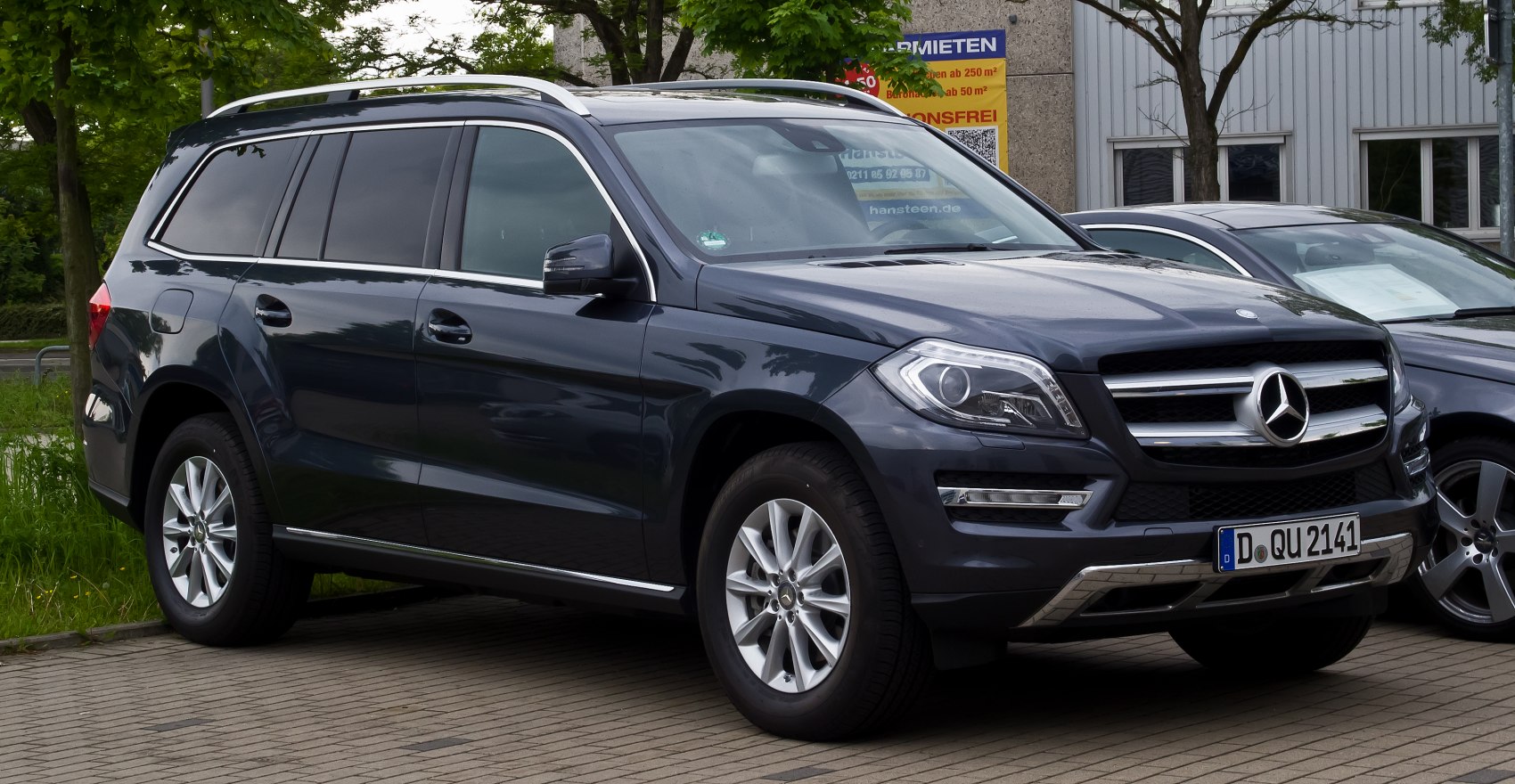 Front and side exterior view of luxury SUV with prominent grille and alloy wheels