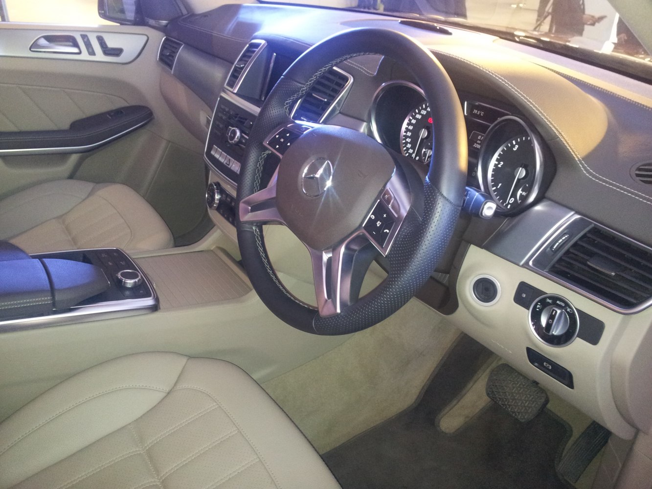 Luxury SUV interior with detailed dashboard and leather-wrapped steering wheel