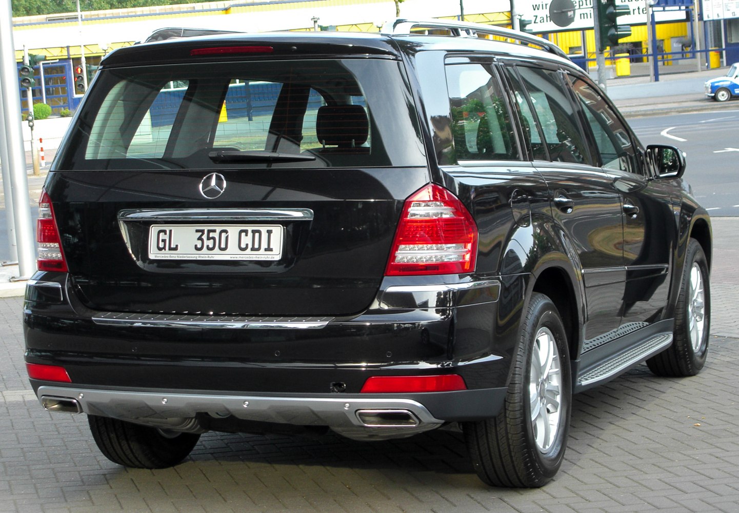 Rear view of large SUV with tail lights and dual exhaust