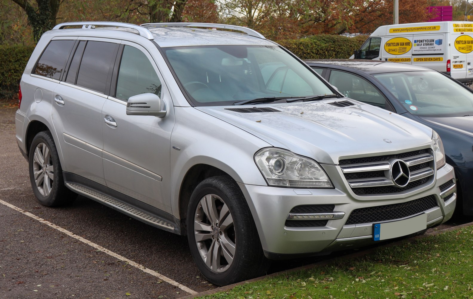 Silver SUV front side view with prominent grille and headlights