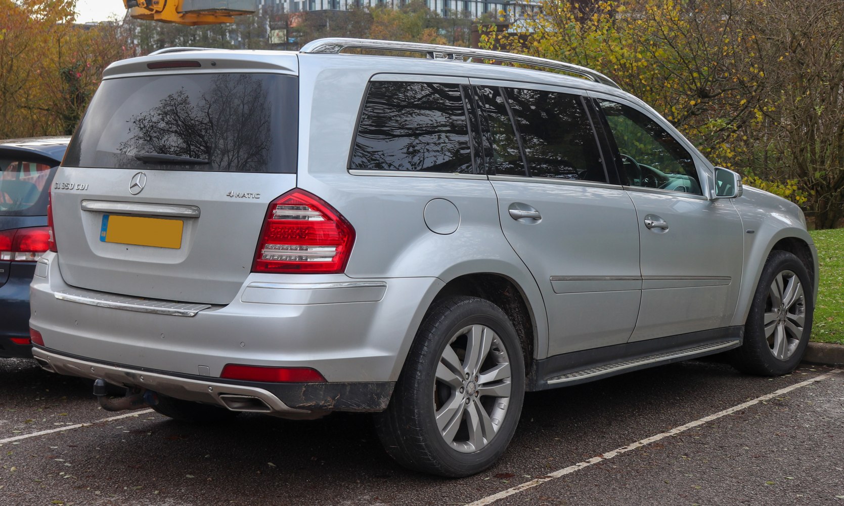 Rear and side view of a large SUV with roof rails and alloy wheels