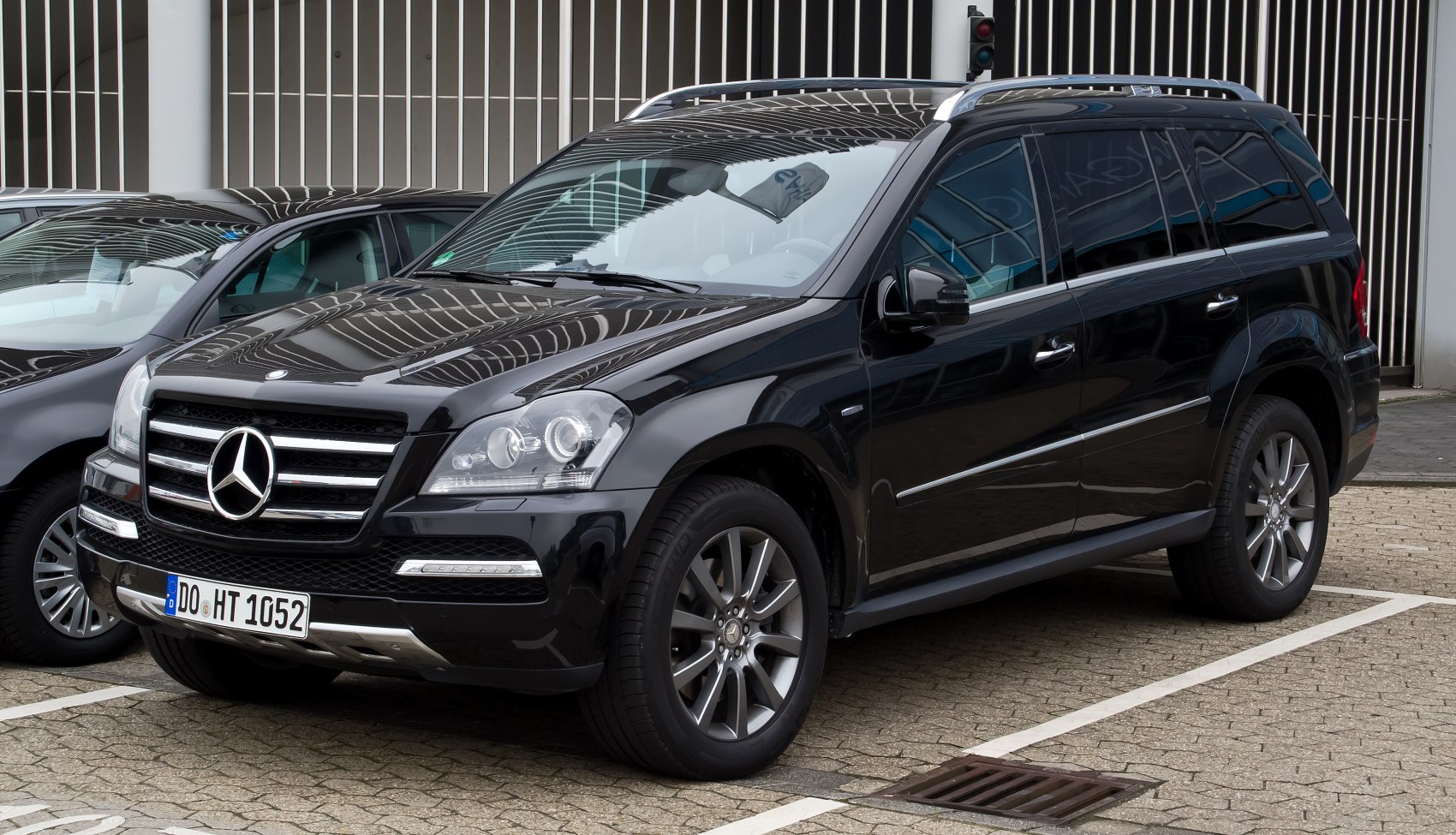 Front-side view of a black large luxury SUV with grille and alloy wheels
