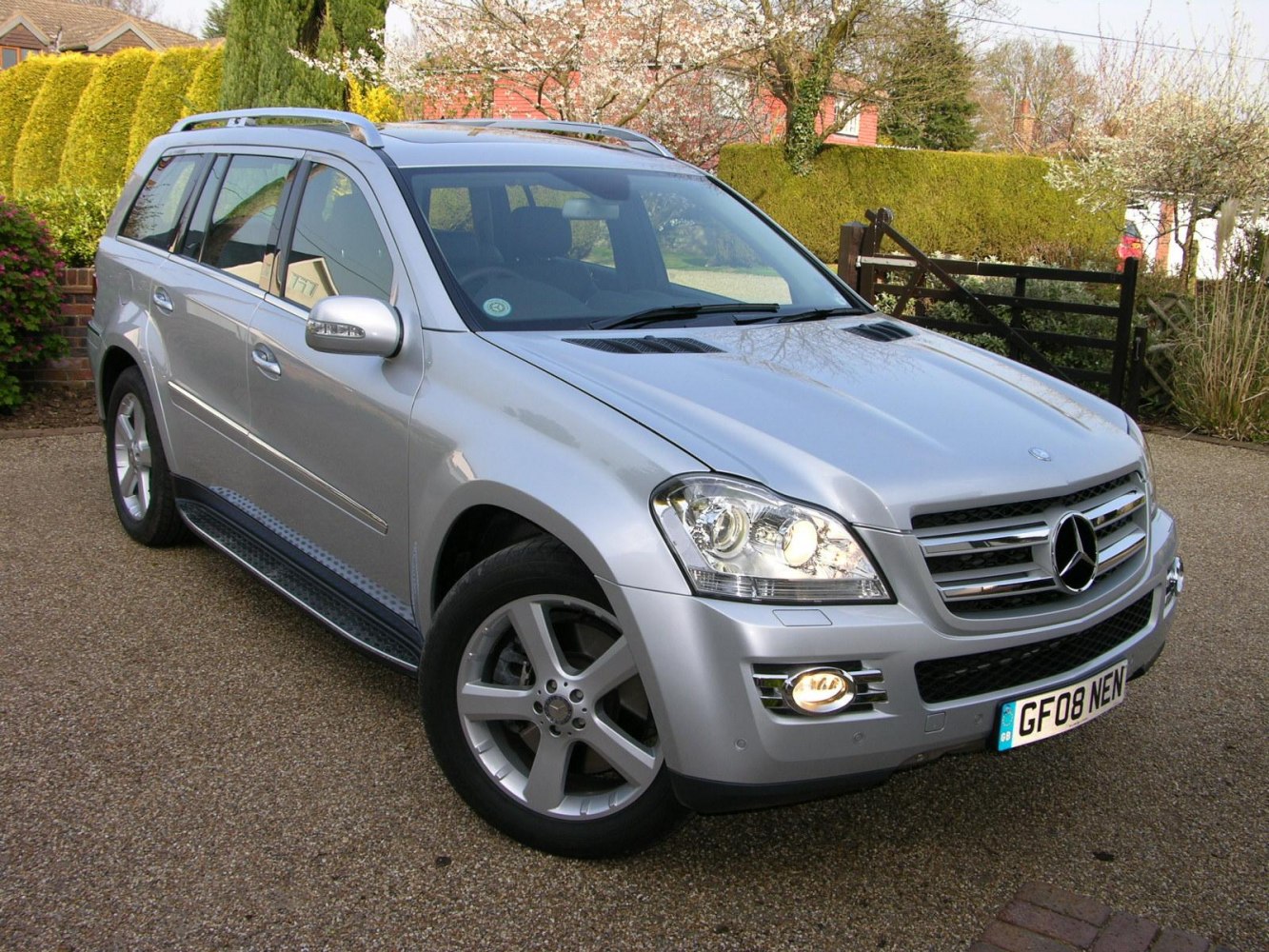 Silver luxury SUV with LED headlights and alloy wheels in outdoor setting