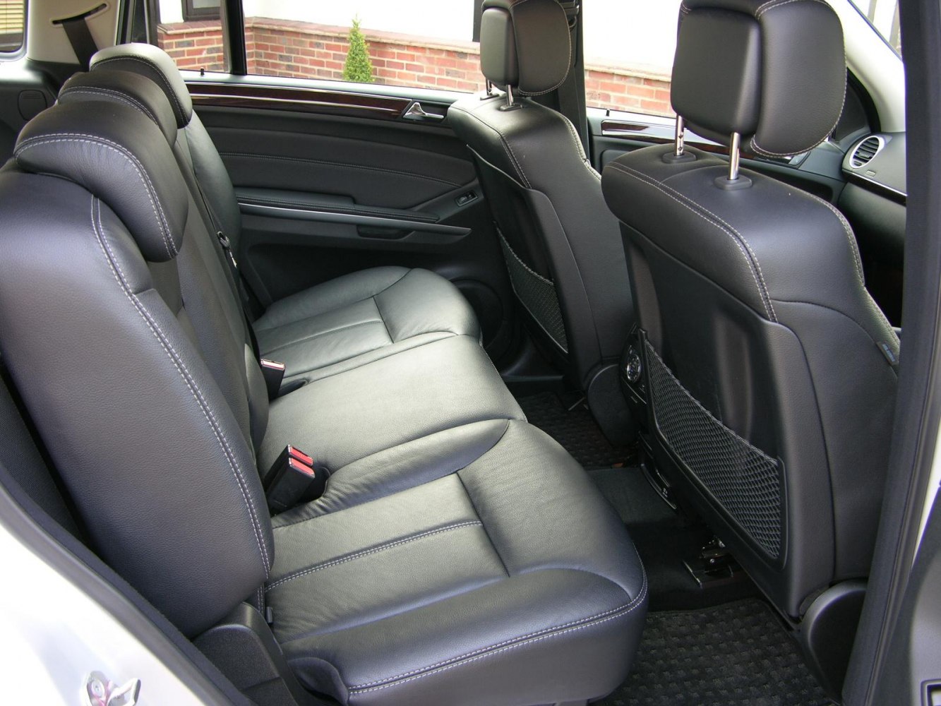 Black leather rear seats with stitching and spacious layout