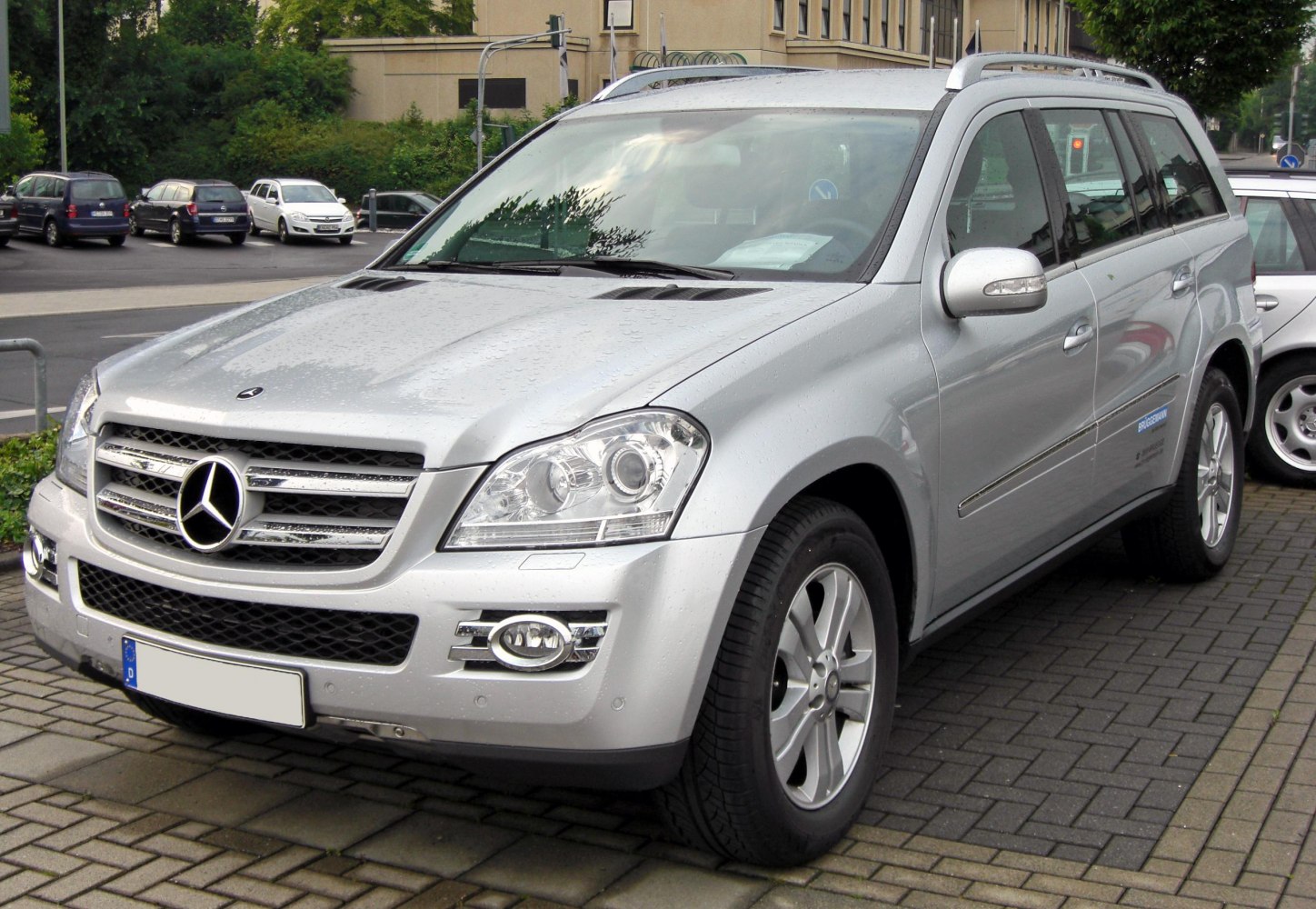 Luxury SUV front with grille, headlights, fog lights, and roof rails