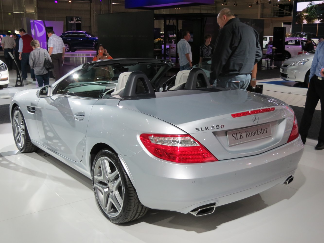 Rear view of silver convertible with dual exhaust and roll bars