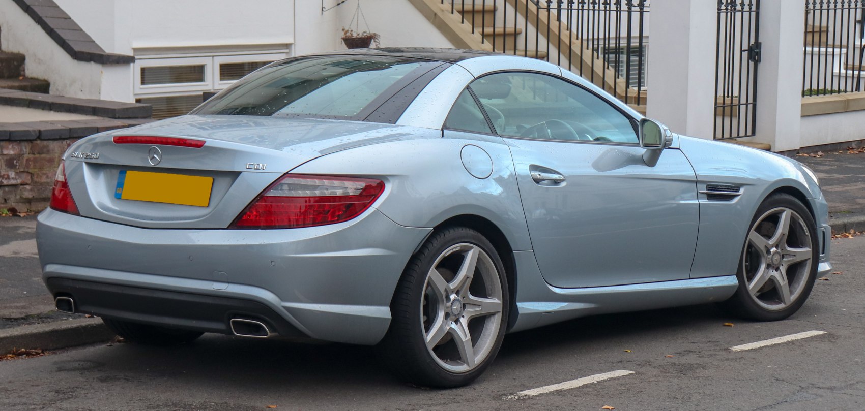 Silver roadster rear side view with alloy wheels and distinctive taillights