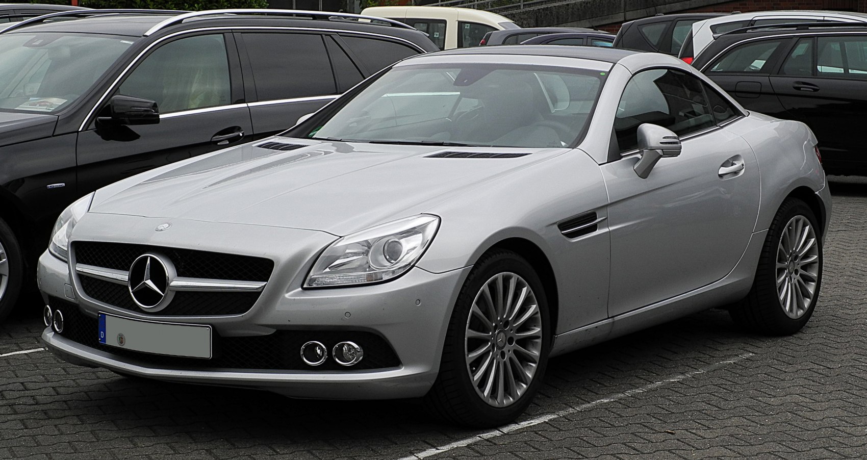 Front and side view of a sleek sporty coupe with distinctive grille and alloy wheels.
