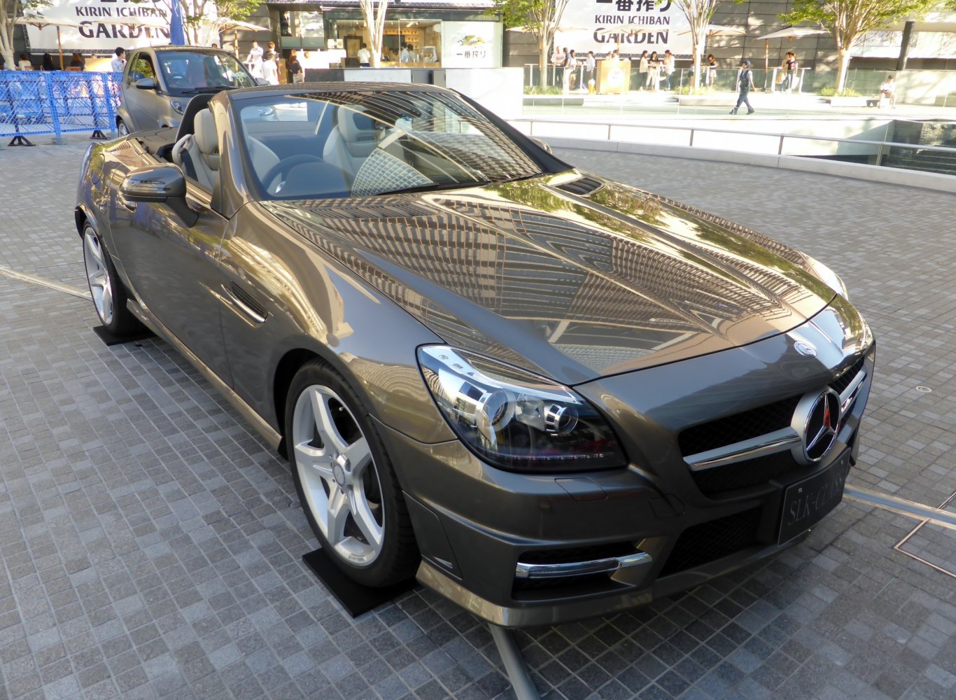 Front view of a sleek convertible with sharp headlights and alloy wheels