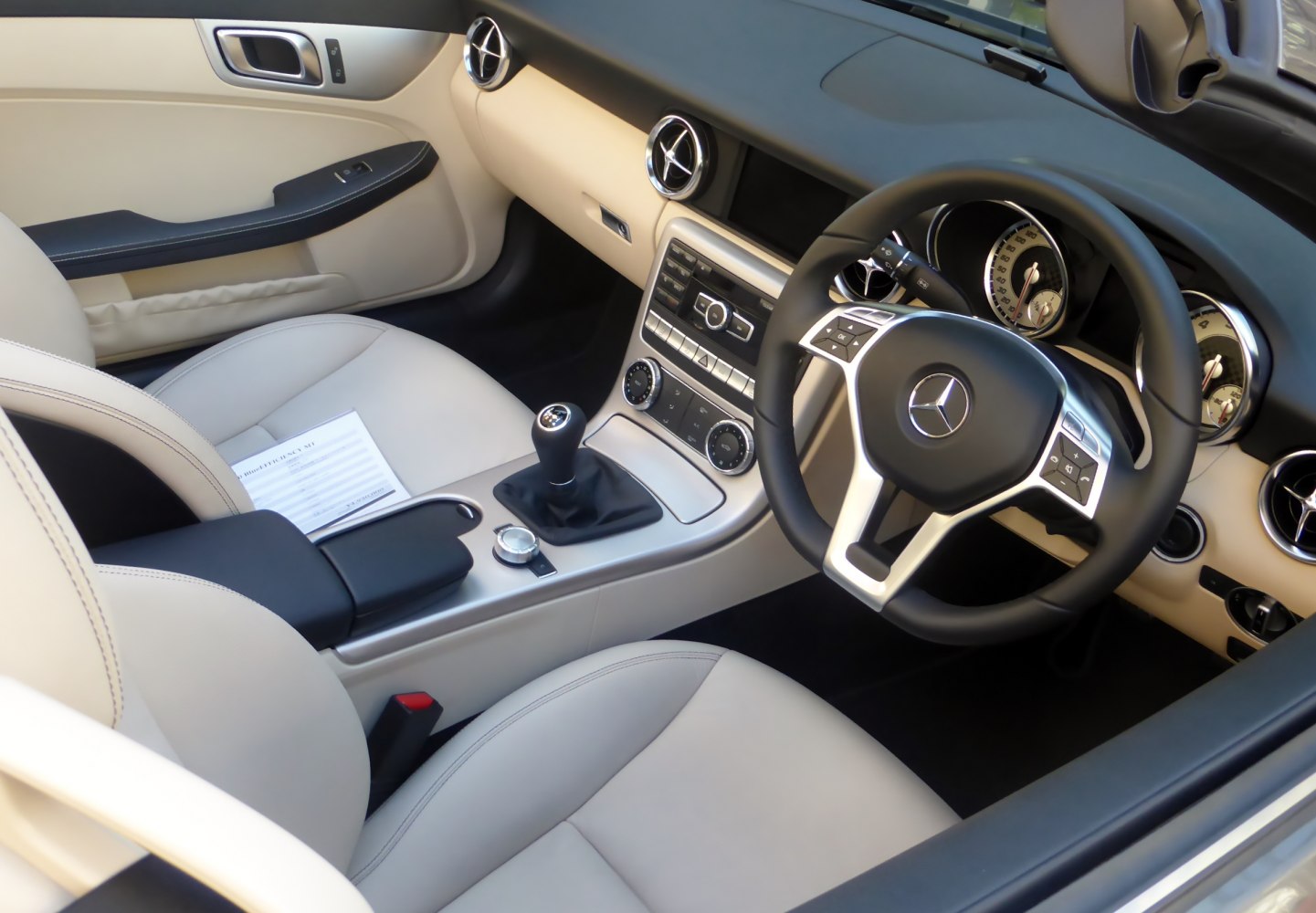 Luxury beige interior with manual transmission and modern dashboard controls