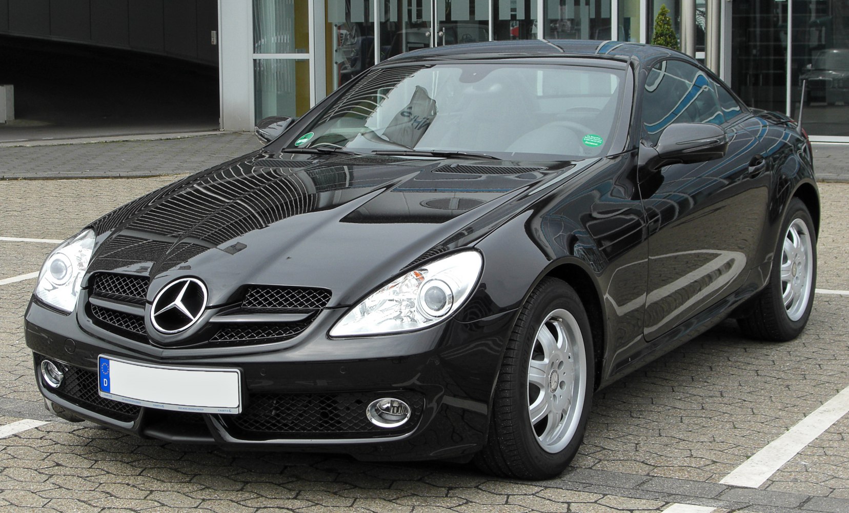 Black sporty coupe with prominent front grille and headlights