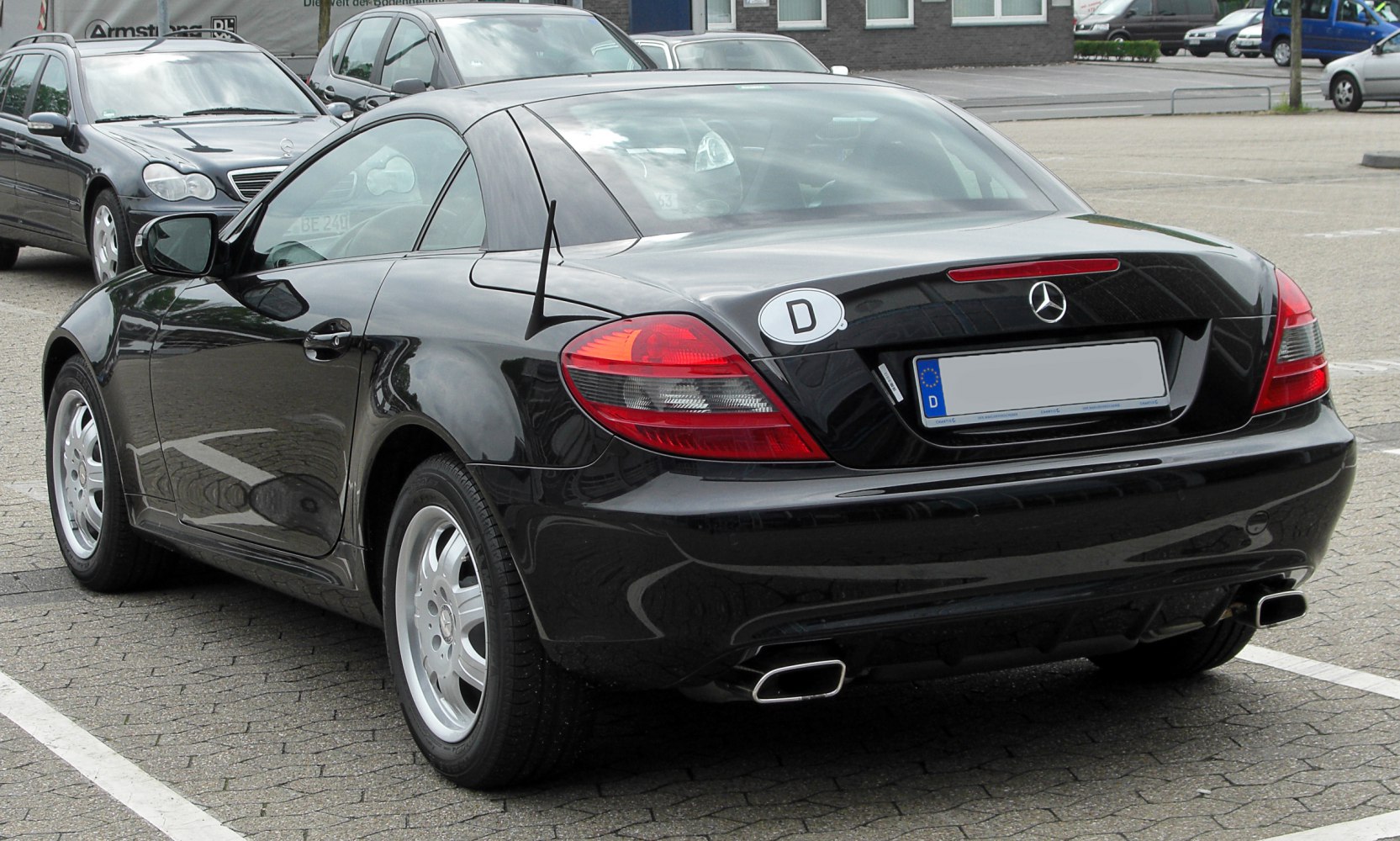 Rear and side view with dual exhaust and sleek tail lights of a sports coupe