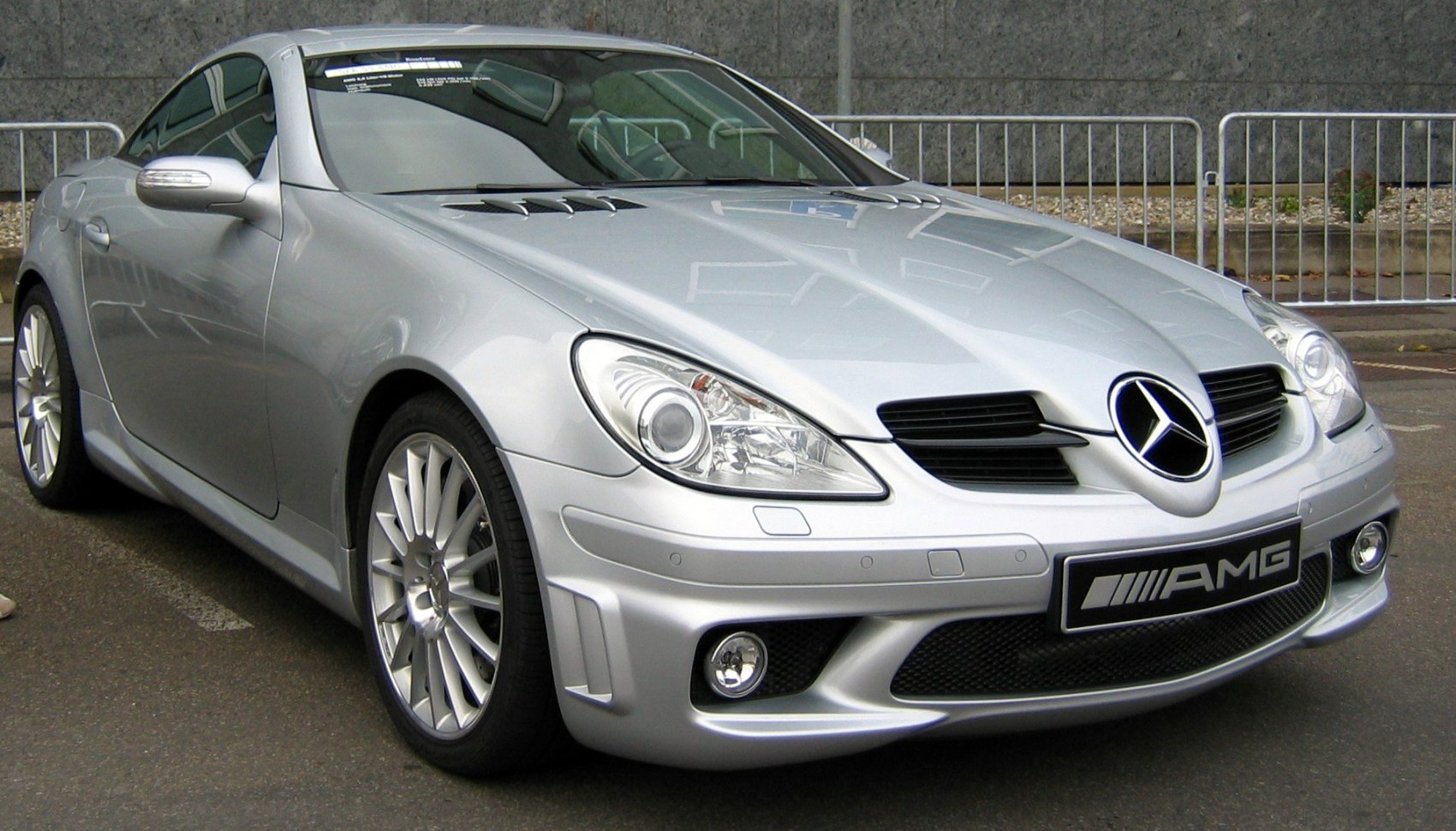 Sporty front view of silver coupe with distinctive headlights and AMG grille