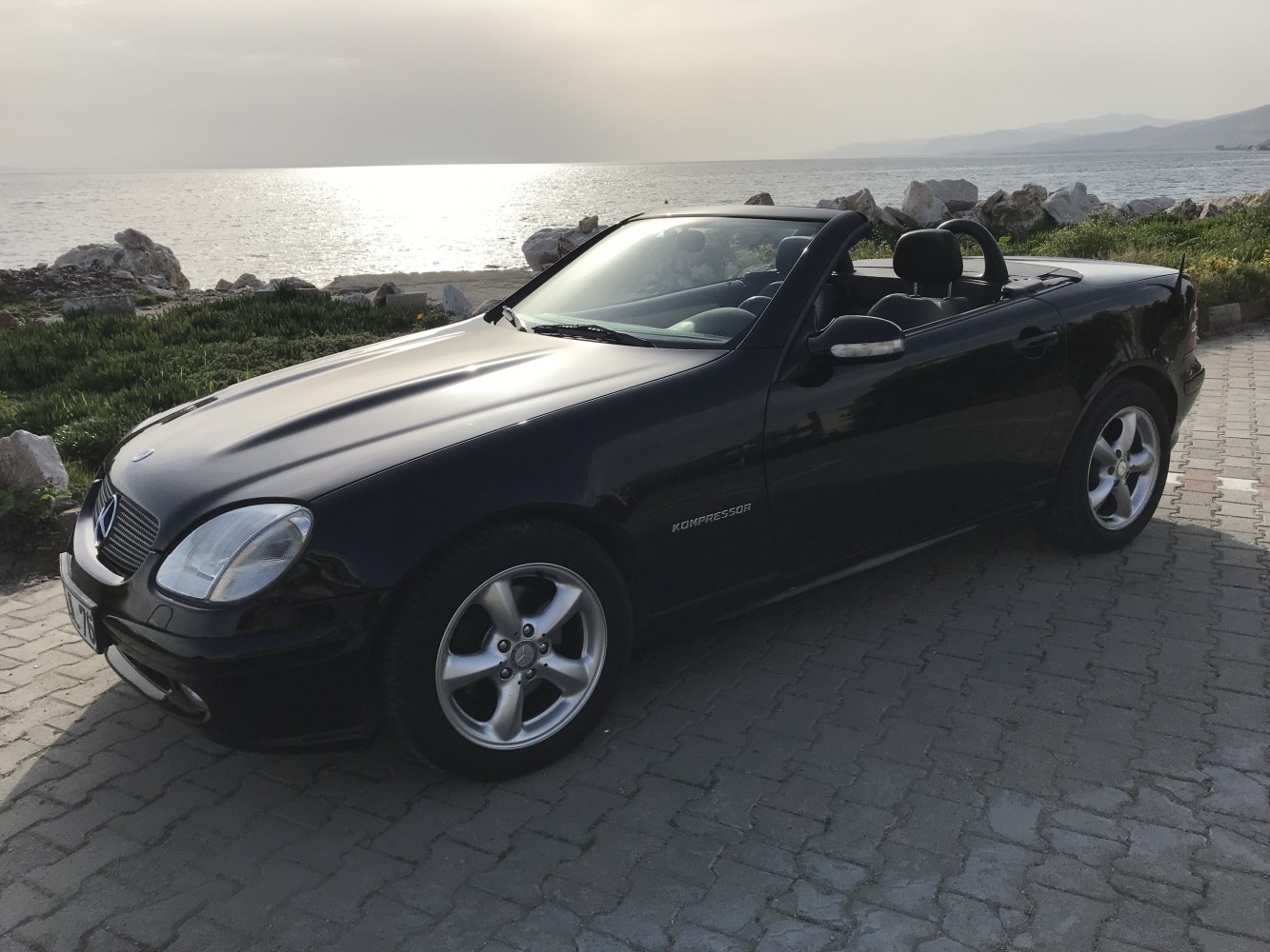 Convertible car front-side view with Kompressor badge
