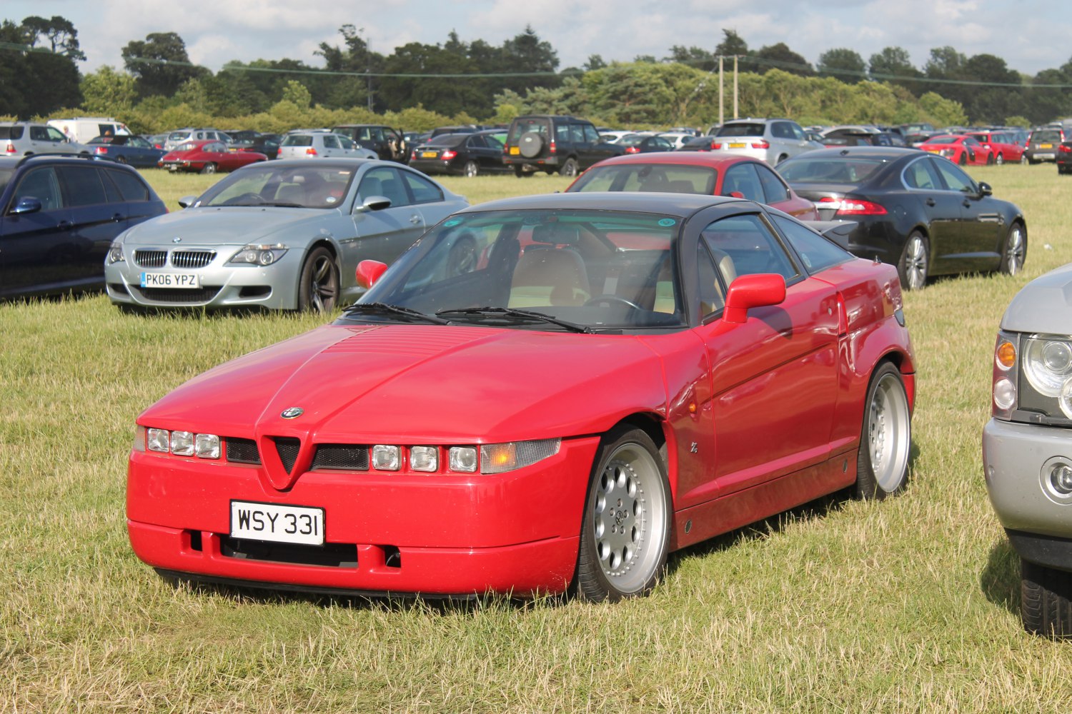 Red vintage sports coupe with angular design and quad rectangular headlights