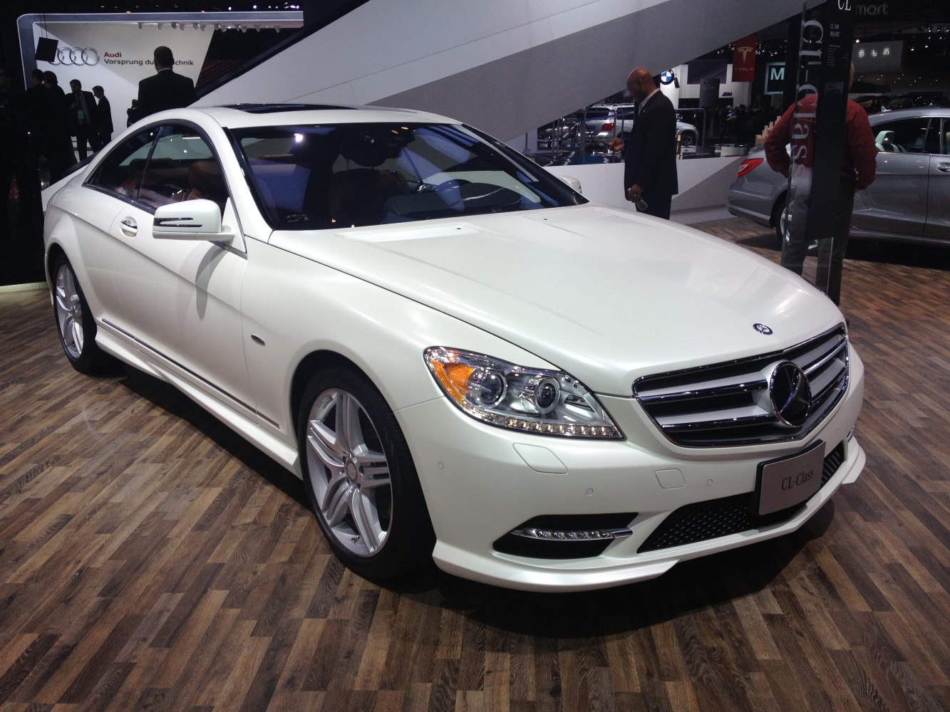 Front view of luxury coupe with modern headlights and alloy wheels